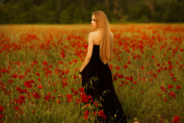 girl with a bouquet of poppies in black dress