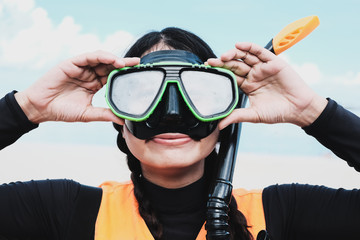 Close-up Asian woman wearing a black half-face snorkels