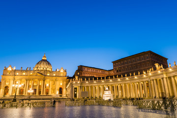 Fototapeta na wymiar Architecture of the St. Peter's Square and Basilica illuminated at dusk, Vatican City