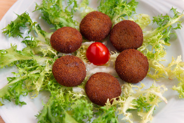 fried aubergine balls from the island of Panarea on a bed of green salad
