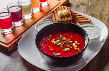 Beetroot soup Traditional Ukrainian or Russian borscht with sour cream in a bowl on wooden table