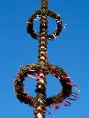 Brauchtum - Maibaum mit Kränzen und Krepppapier