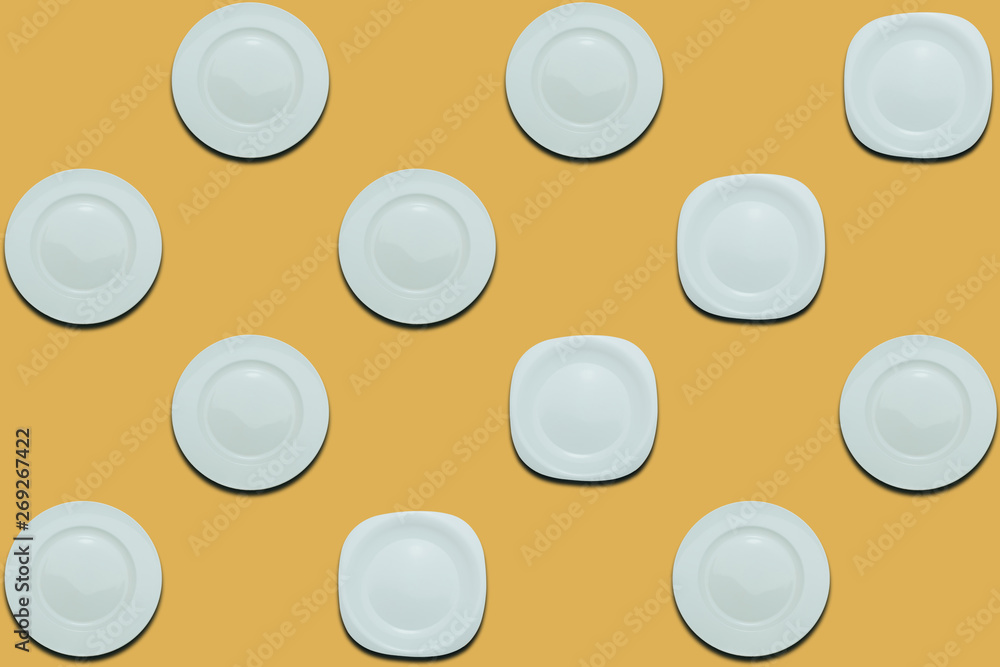 Poster white round plates and four different plates on a yellow flat background. copy space