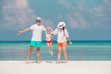 Young family on white beach during summer vacation