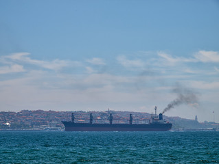 View to Bosporus strait large cargo ship on a summer day, Istanbul, Turkey.