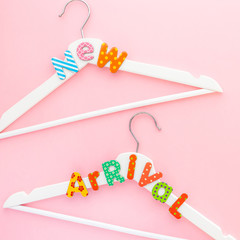 White hangers with sale text on pink background