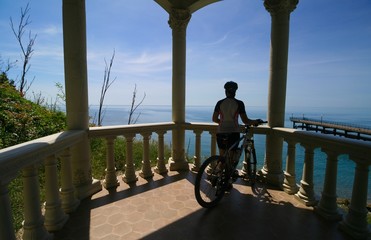 Cyclist admires the view of the Black sea, Krasnodar region, Russia.