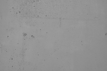 Grauer Hintergrund, Betonwand in Grau im Industrial Style. Grau Textur mit rissigen und rauen Strukturen und Beschädigungen.