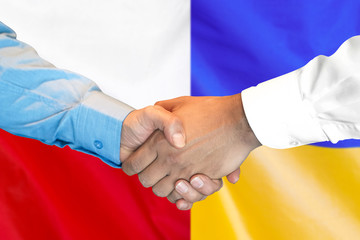 Business handshake on the background of two flags. Men handshake on the background of the Poland and Ukraine flag. Support concept