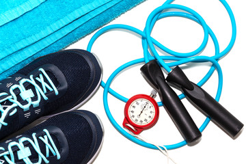 sneakers and jump rope on light background.