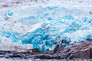 At the edge of the blue shining glacier Nordenskiöldbreen near