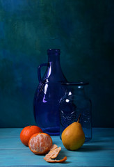 Still life with a purple vase and fruit