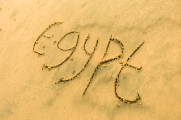 Word Egypt with heart on sand beach in the summer on vacation inspire to travel.  Romantic travel for love couples or family holidays. resort countries and cities for tourists. Relaxing sign on sand