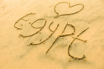 Word Egypt with heart on sand beach in the summer on vacation inspire to travel.  Romantic travel for love couples or family holidays. resort countries and cities for tourists. Relaxing sign on sand