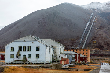 The sudden abandoned russian mining town Pyramiden, snowcaped mo