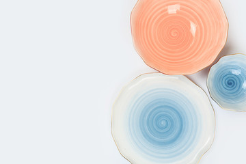 Set of colored ceramic plates on white background