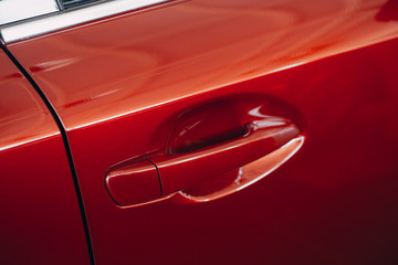 Using Car door handle red color for customers. Using wallpaper or background for transport and automotive image. Red car door handle - Powered by Adobe