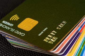 Close-up credit card where the chip is clearly visible on a black background.