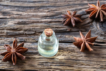 Obraz na płótnie Canvas A bottle of star anise essential oil with star anise