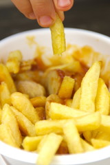 Close up fries with german currywurst