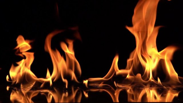 Slow Motion video shooting,Fire Flames Igniting And Burning.Real fire , A line of real flames ignite on a black background.