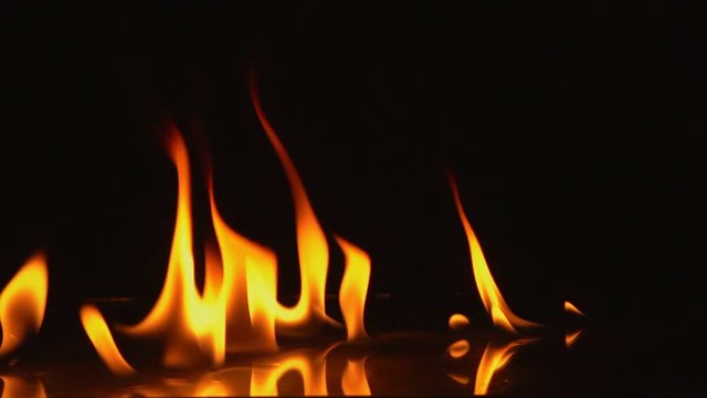 Slow Motion video shooting, Fire Flames Igniting And Burning goes off.Real fire, A line of real flames ignite on a black background.