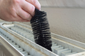Cleaning a radiator with a brush