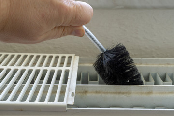 Cleaning a radiator with a brush