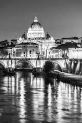 Fototapeta premium St Peters Basilica in Vatican and Ponte Sant'Angelo Bridge over Tiber River at dusk. Romantic evening cityscape of Rome, Italy
