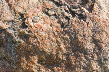 Background of granite. Texture of granite stone. Pattern of roughened surface. Texture of brown stone