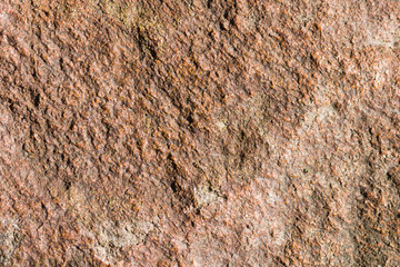 Background of granite. Texture of granite stone. Pattern of roughened surface. Texture of brown stone