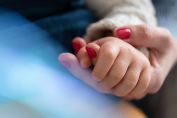 Mother and daughter holding hands