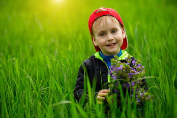 Portrait of young boy in nature, park or outdoors. Concept of happy family or successful adoption or parenting.Happy smiling boy