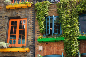 facade detail in Covent Garden with colorful houses. It contains several health food cafes and values driven retailers .