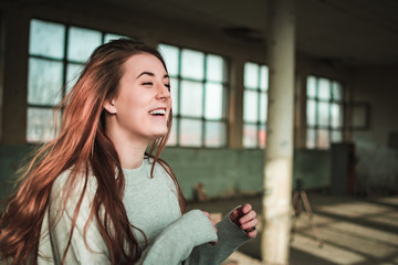 Cute, redhead teenage girl in gray sweater. Human emotions, expressions