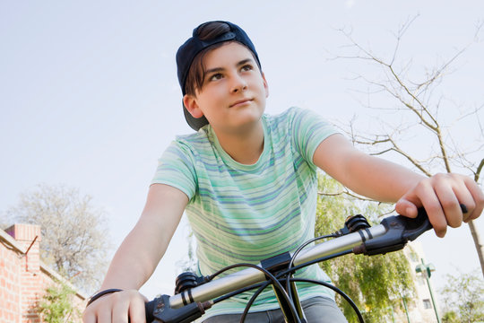 Teenage boy cycling in park
