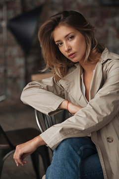 Young woman wearing grey trench coat