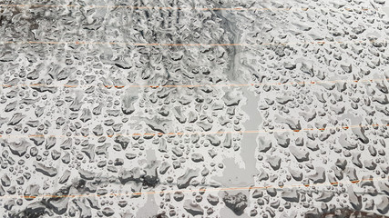 Waterdrops on a glass surface with heated glass