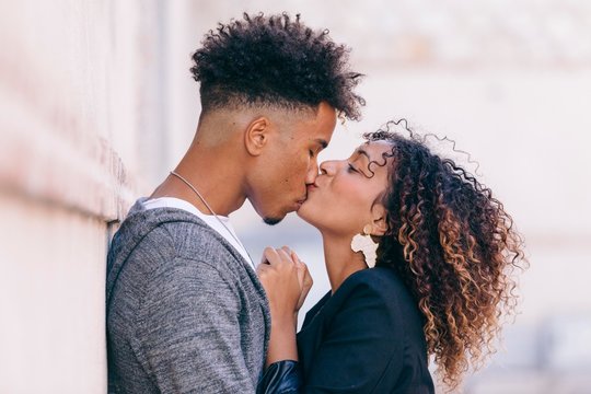 Loving Girlfriend Showing Affection In Public. Couple Having A Tender And Sweet Little Kiss On The Nose