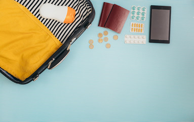 flat lay of staff for summer vacation on blue background. summer travel concept with copy space