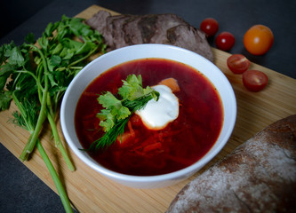 a plate of borsch with a loaf of bread