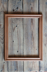 empty picture wooden frame on a wooden table top view