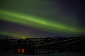 Northern lights with hut or bungalow