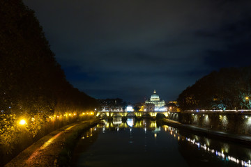 Night scene of Rome, Tevere river with basilica in background