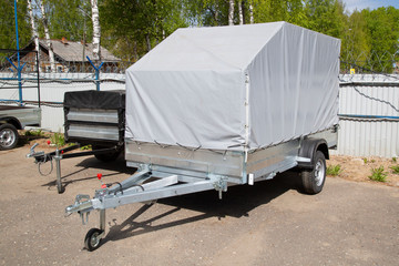 Open car trailer. Trailer store. Assembly of car trailers.