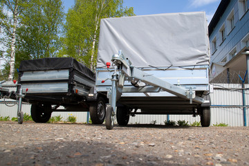 Open car trailer. Trailer store. Assembly of car trailers.