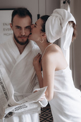 Guy in a white coat and a girl in a towel