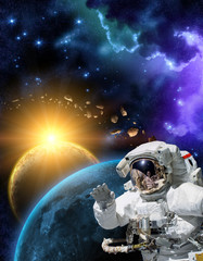 Obraz na płótnie Canvas Astronaut in space suit in the outer space with the sunrise on planet and asteroids. Elements of this image furnished by NASA.