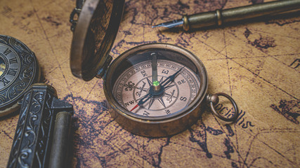 Fototapeta na wymiar Antique Bronze Compass On Old World Map