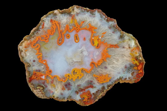 A cross section of the agate stone filled with quartz and chalcedony. Multicolored silica rings colored with metal oxides are visible.